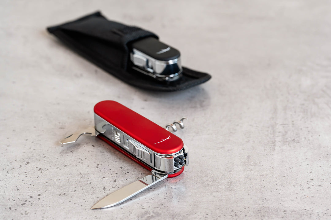 Two Sizzle Scout USB rechargeable lighter/survival devices in red and black color. Red device shows blade, corkscrew and opener extended. black device tucked inside black protective pouch